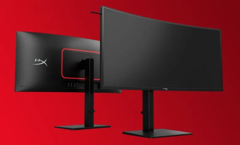Two HyperX Armada 27 gaming monitors on stands against a red background.