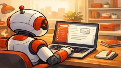 Cartoon robot sits at desk, using laptop for email.