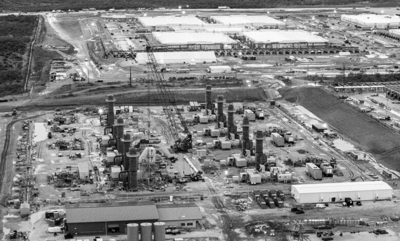 Black and white aerial view of a large industrial complex.