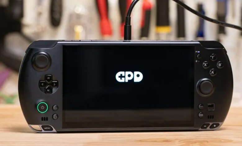 GPD handheld gaming device with GPD logo on the screen.