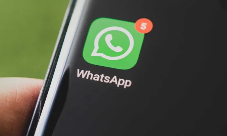 Close-up of WhatsApp icon on a smartphone screen with a notification badge.