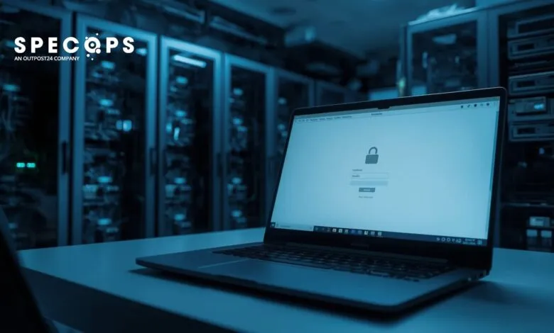 Laptop displays login screen with padlock icon in a server room.