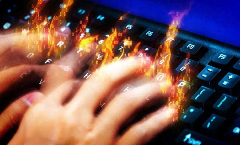 Hands rapidly type on keyboard with binary code flames overlayed.