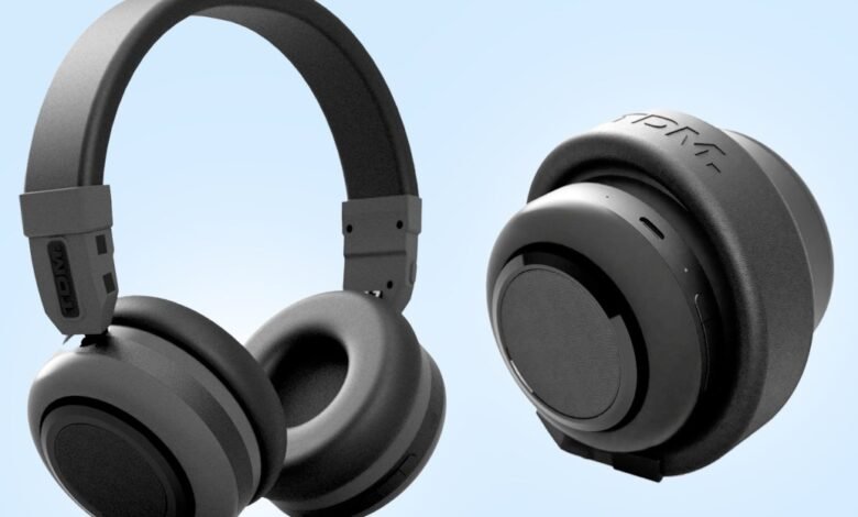 Black TDM Neo headphones, one folded, against a light blue background.