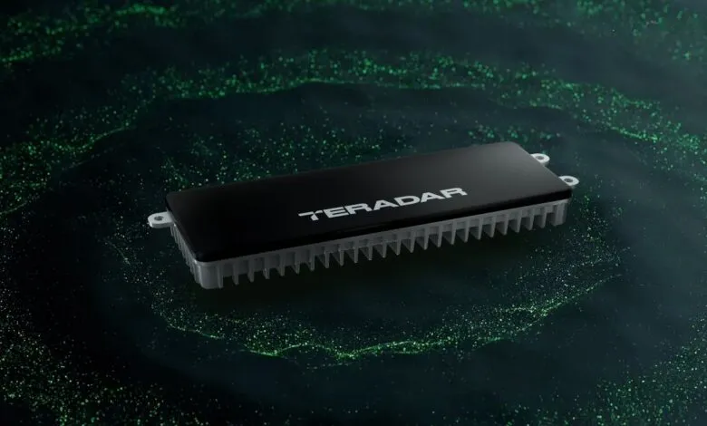 Teradar device on a dark background with green particle effects.