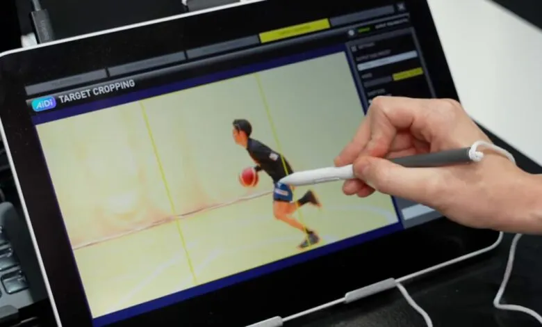Tablet displaying basketball player with hand using stylus for target cropping.