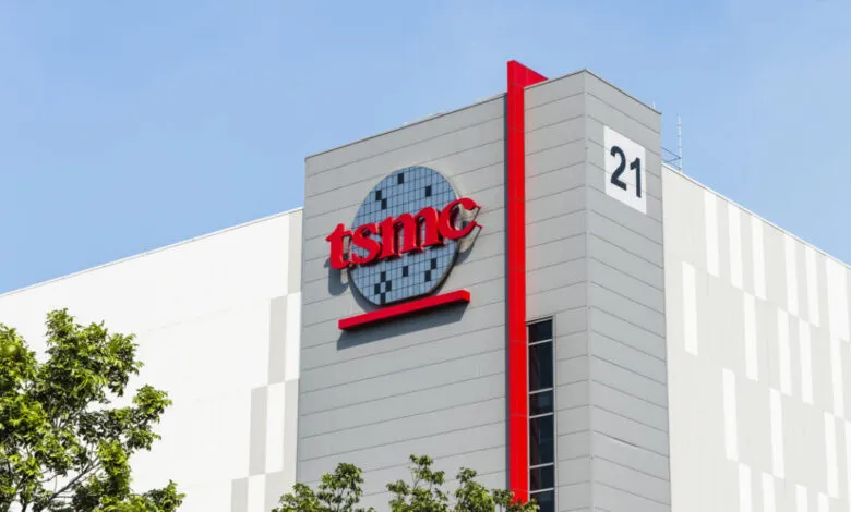 TSMC factory building exterior with logo and number 21 on a sunny day.