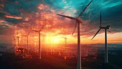 Wind turbines on a hill with a sunset and digital overlay.