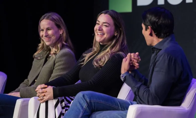 Panel discussion with three people on stage, smiling and engaged.