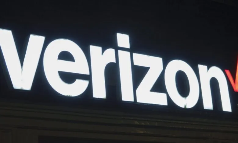 Illuminated Verizon logo sign with white letters and red checkmark.
