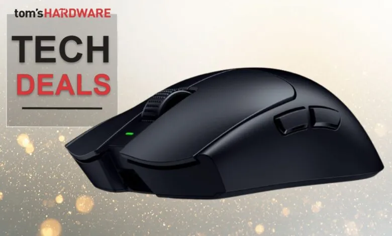 Black wireless gaming mouse with side buttons and scroll wheel.