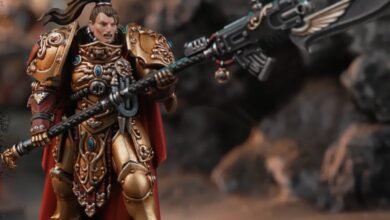 Female Adeptus Custodes model with ornate gold armor and power halberd.