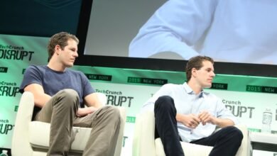 Cameron and Tyler Winklevoss sitting on stage at TechCrunch Disrupt.