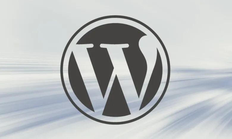 WordPress logo, a 'W' inside a circle, on a blurred background.