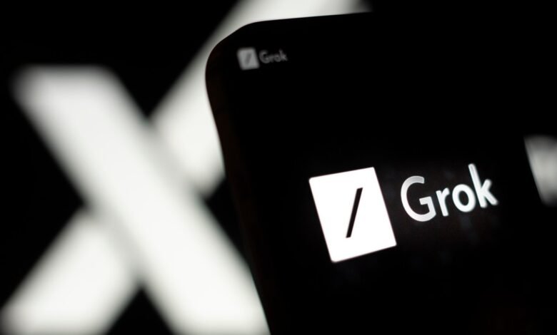 Close-up of Grok AI logo on a dark screen, X in background.