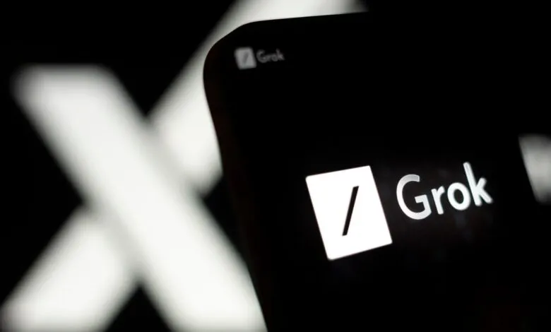 Close-up of Grok AI logo on a dark screen, X in background.