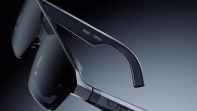 Close-up of sleek ROG x XREAL AR glasses with dark lenses and futuristic design.
