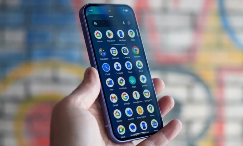 Hand holding a smartphone displaying the Google Pixel home screen.