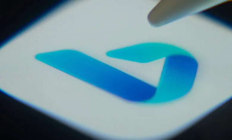 Close-up of the Microsoft Bing logo on a screen with a stylus pointing at it.