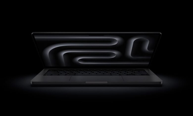 Sleek black MacBook Pro with glowing maze wallpaper on screen.