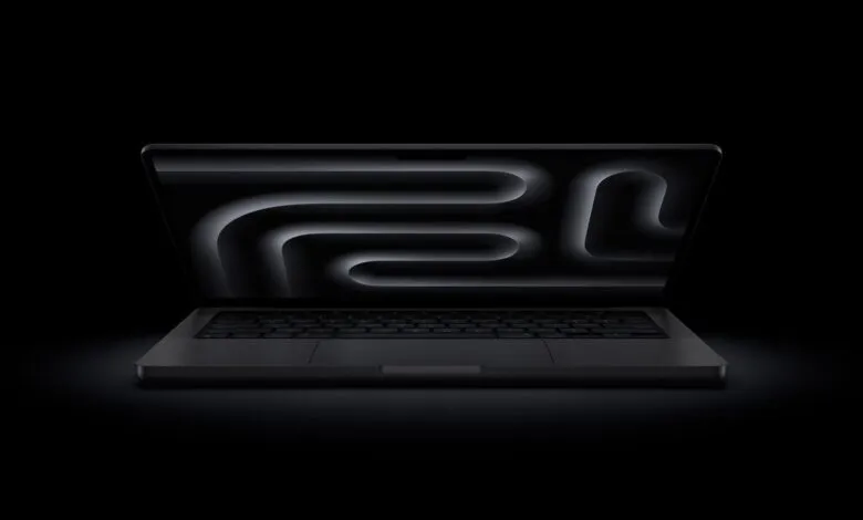 Sleek black MacBook Pro with glowing maze wallpaper on screen.