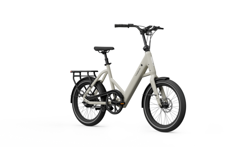 Beige Tinways e-bike with black accents, rear rack, and small wheels.