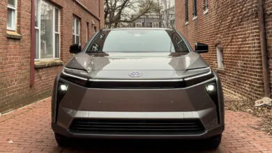Front view of a gray Toyota bZ4X electric SUV on a brick street.