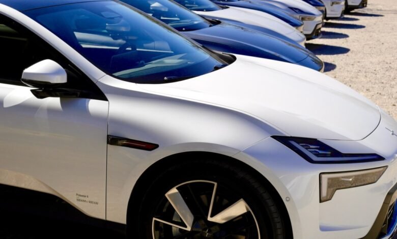 Line of Polestar 4 electric vehicles in white and dark colors.
