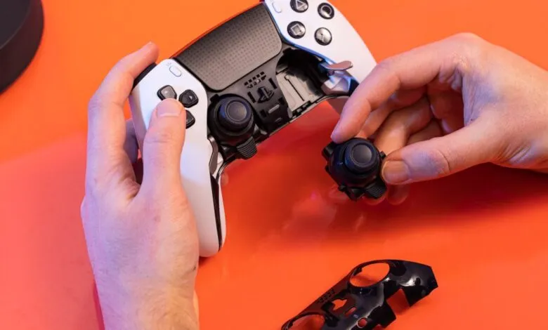 Hands replacing joystick on white DualSense Edge controller.