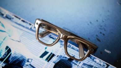 Ray-Ban Meta smart glasses on a blue patterned surface.