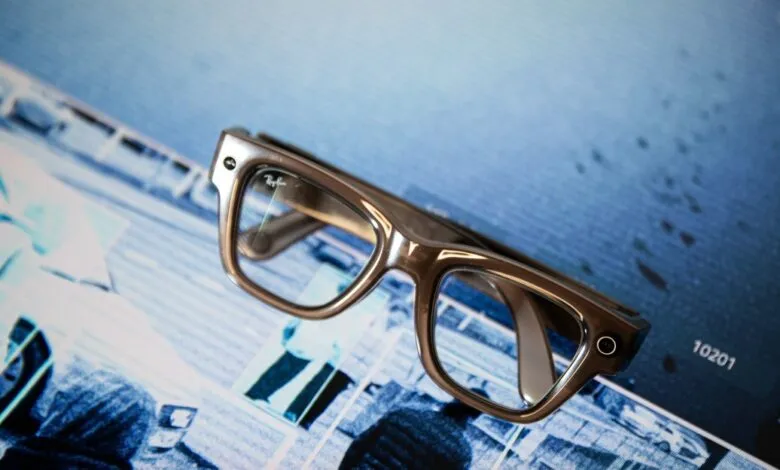 Ray-Ban Meta smart glasses on a blue patterned surface.