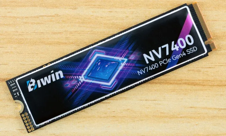 Biwin NV7400 PCIe Gen4 SSD on a light wood surface.