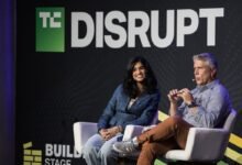 Two speakers at TechCrunch Disrupt conference sitting on stage.