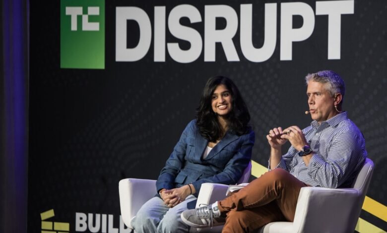 Two speakers at TechCrunch Disrupt conference sitting on stage.