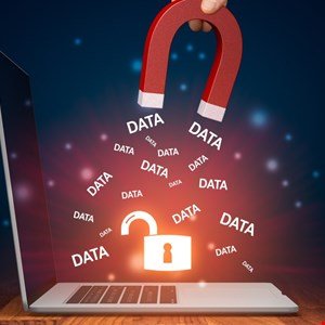 Magnet pulling data from an open padlock on a laptop screen, symbolizing data vulnerability.