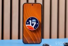 Smartphone displaying Android 17 logo on orange background.