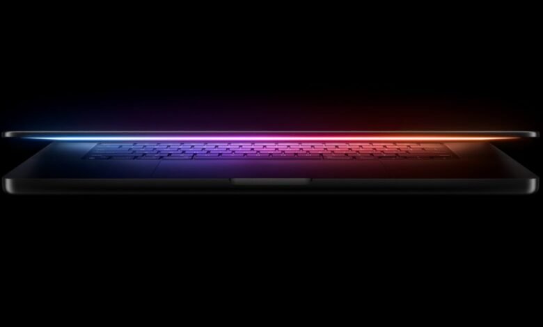 Sleek laptop with a glowing, colorful keyboard against a black background.