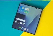 Foldable tablet on colorful background with faces on either side.
