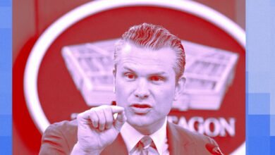 Man speaking with Pentagon logo in background.