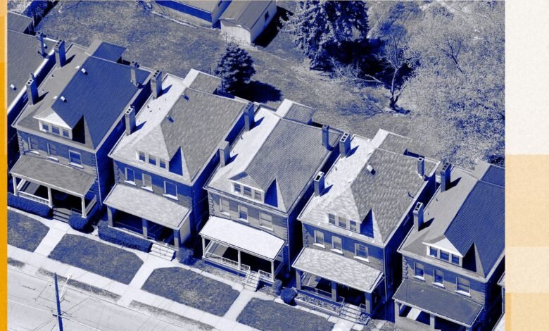 Aerial view of a row of similar two-story houses with front porches and small yards.