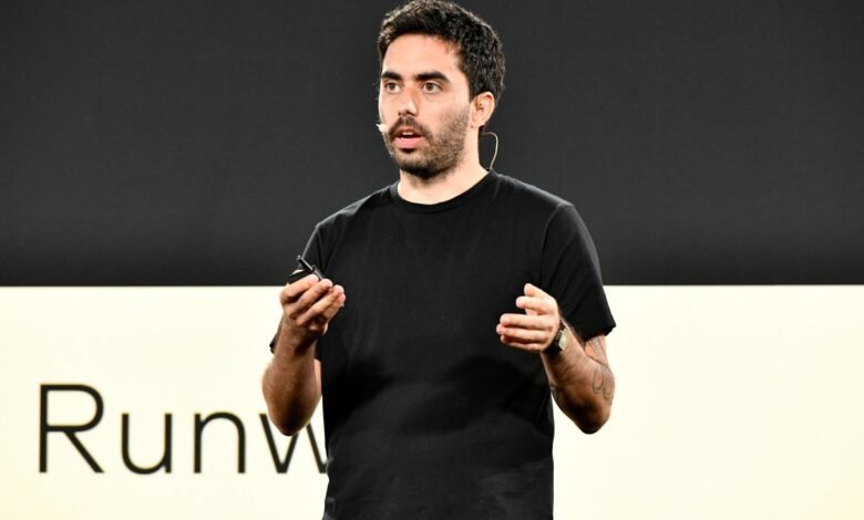 Man in black shirt presents on stage with 'Runway' logo visible.