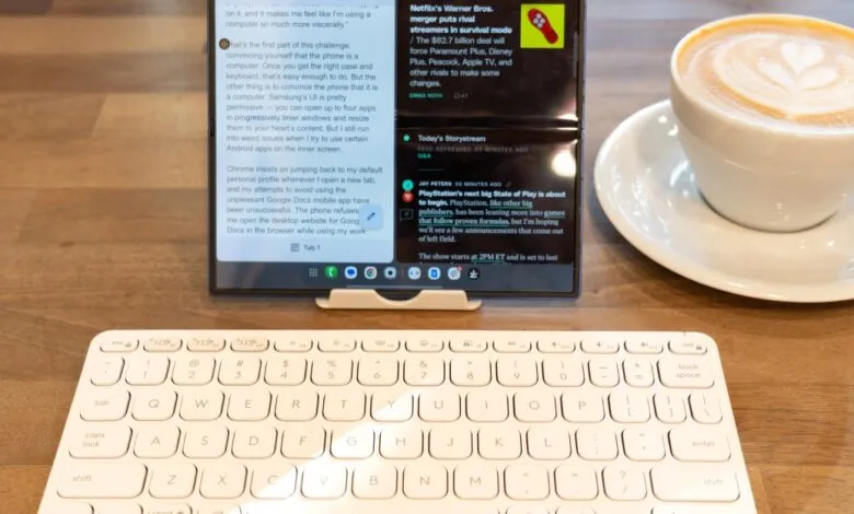 Tablet with keyboard and coffee on wooden desk, productivity setup.