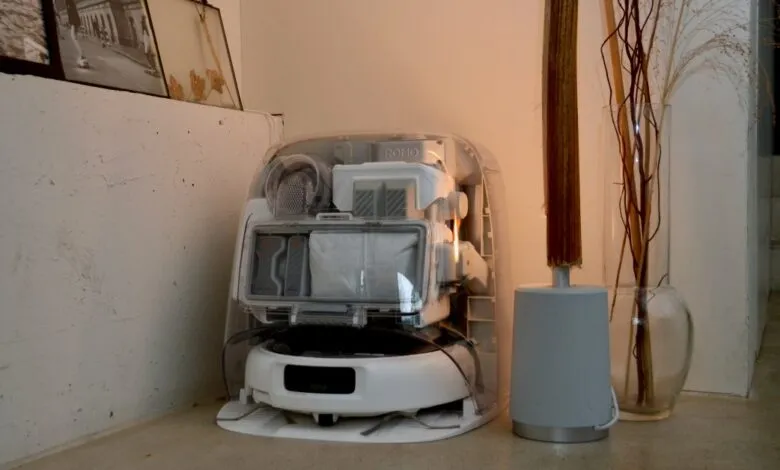 Robot vacuum cleaner with transparent cover showing internal components.