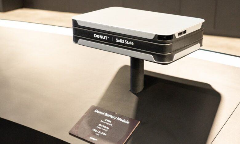 Donut Solid State battery module on display stand with product information card.