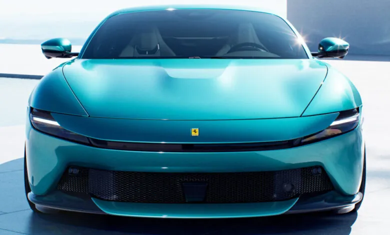 Front view of a turquoise Ferrari Roma Spider with sleek headlights.