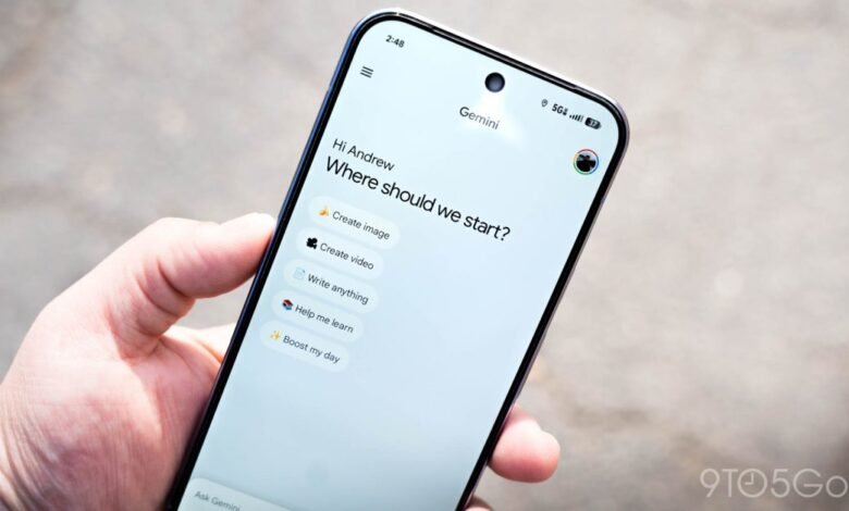 Hand holding smartphone displaying Google Gemini app interface.