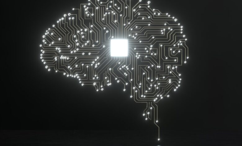 Brain-shaped circuit board with glowing chip in center on dark background.