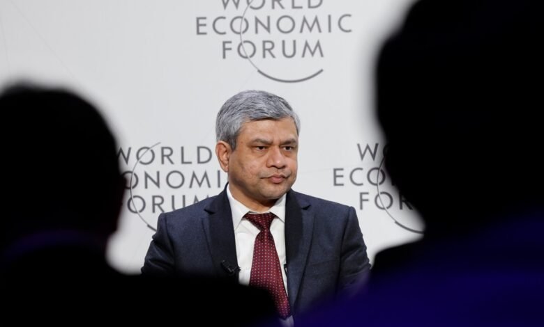 Man in suit at World Economic Forum, looking serious.