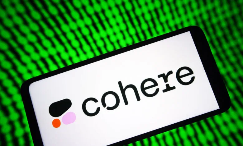 Smartphone displays the Cohere logo against a green digital background.