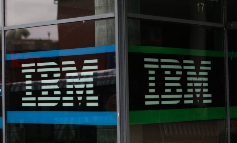 IBM logo displayed on a glass window with blue and green accents.